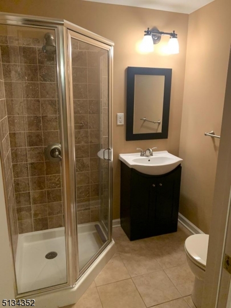 33 Diamond Spring Road, Unit 1C Denville, NJ 07834 - Photo 8 of 8 a bathroom with a sink a mirror and a shower