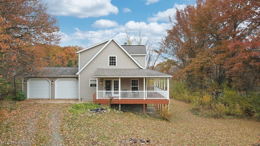 763 Pontius Road Mogadore, OH 44260 - Photo 1 of 20 FRONT VIEW WITH WRAP AROUND PORCH AND TWO CAR ATTACHED GARAGE.