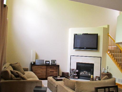 279 Ridge Road North Aurora, IL 60542 - Photo 3 of 16 a living room with furniture a flat screen tv and a fireplace