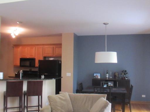 279 Ridge Road North Aurora, IL 60542 - Photo 4 of 16 a living room with furniture a flat screen tv and kitchen view