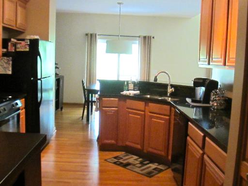 279 Ridge Road North Aurora, IL 60542 - Photo 5 of 16 a kitchen with stainless steel appliances granite countertop a sink stove and refrigerator