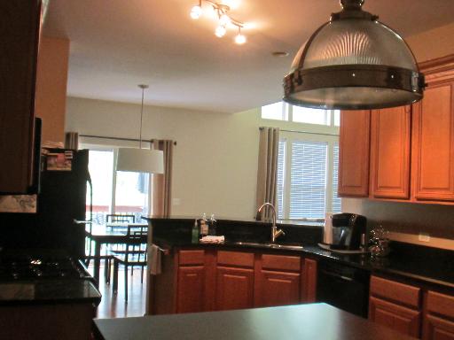 279 Ridge Road North Aurora, IL 60542 - Photo 7 of 16 a kitchen with granite countertop a sink stainless steel appliances and cabinets