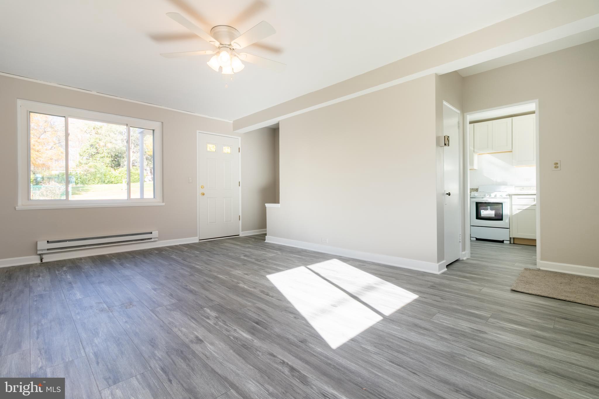 3 Ridge Road Greenbelt, MD 20770 - Photo 2 of 16 an empty room with wooden floor and windows