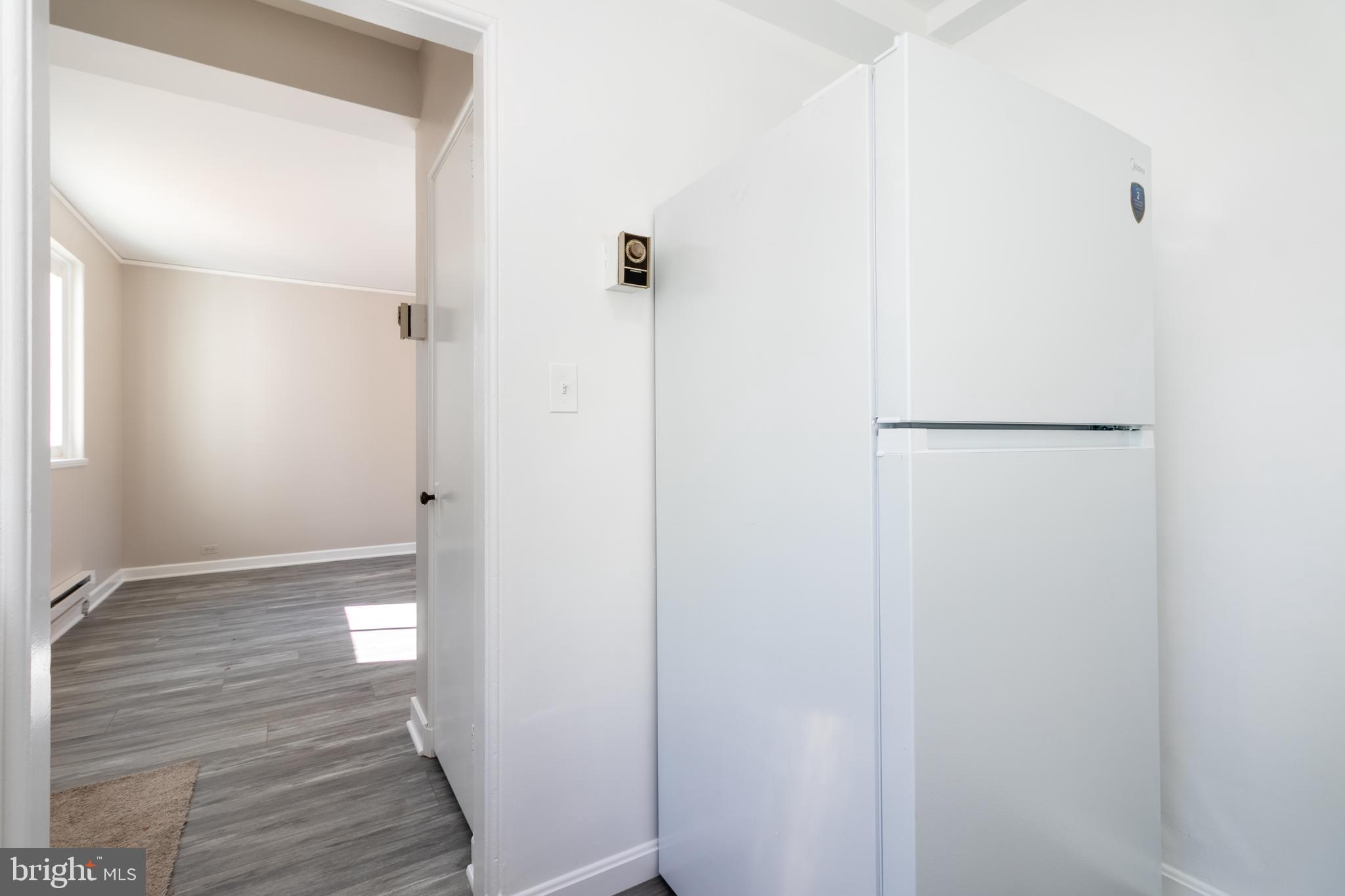 3 Ridge Road Greenbelt, MD 20770 - Photo 6 of 16 a view of hallway with wooden floor