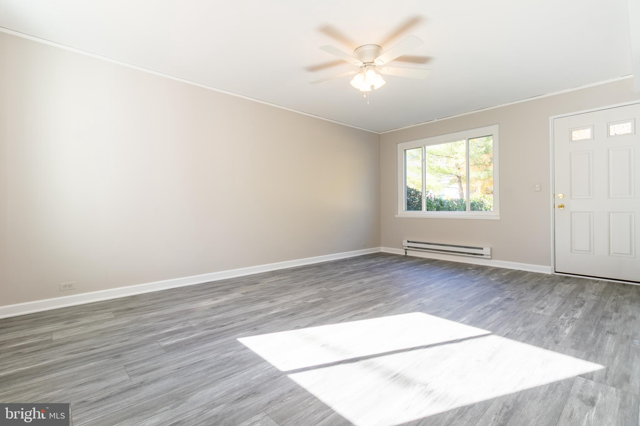 3 Ridge Road Greenbelt, MD 20770 - Photo 7 of 16 an empty room with wooden floor and window