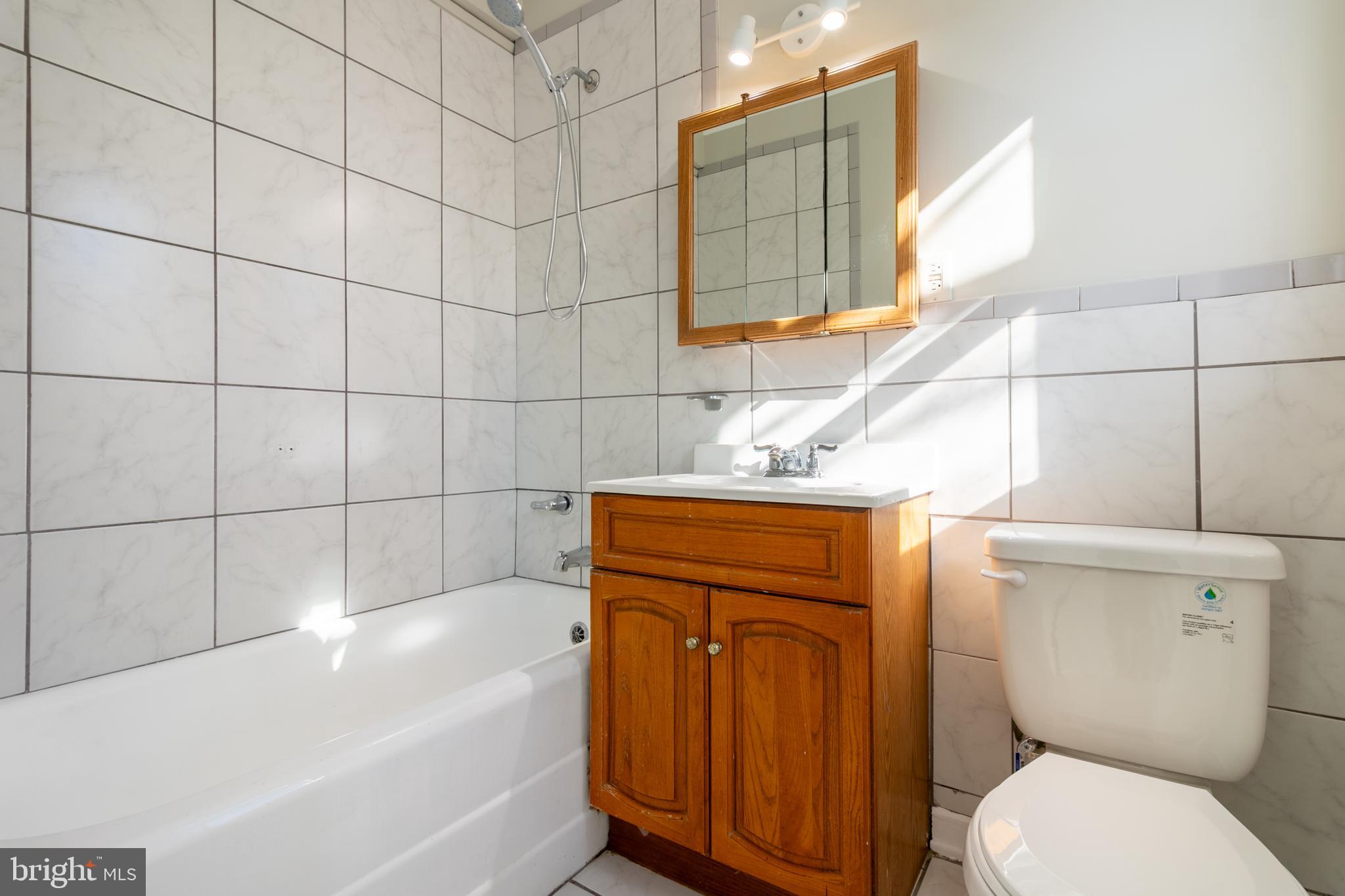 3 Ridge Road Greenbelt, MD 20770 - Photo 10 of 16 a bathroom with a toilet a sink and bathtub