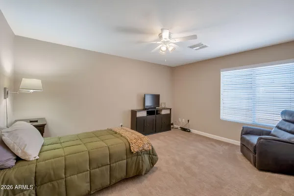 a bedroom with a bed and window