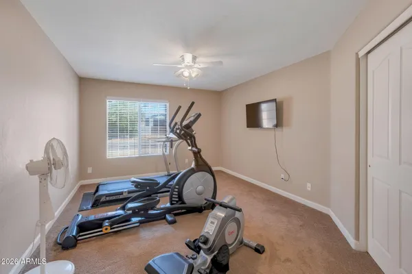 a room with gym equipment and windows