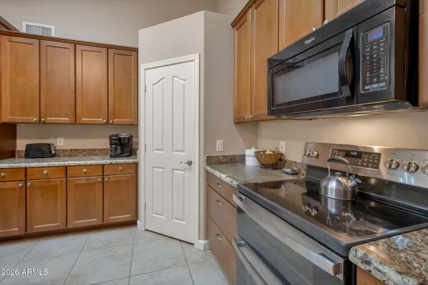 a kitchen with stainless steel appliances granite countertop a sink stove and microwave