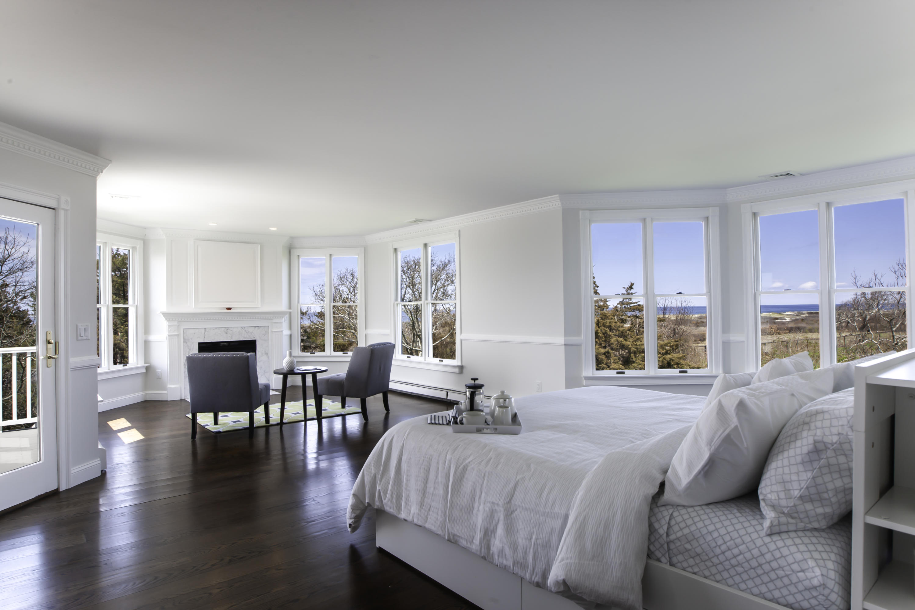 41 Torrey Road Sandwich, MA 02537 - Photo 24 of 34 a spacious bedroom with a balcony a bed and a large window with wooden floor