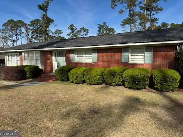 front view of house with potted plants in front of it