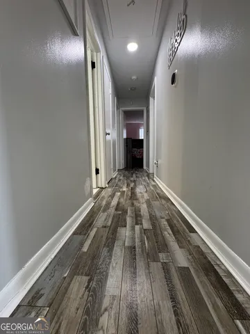 a view of a hallway with wooden floor