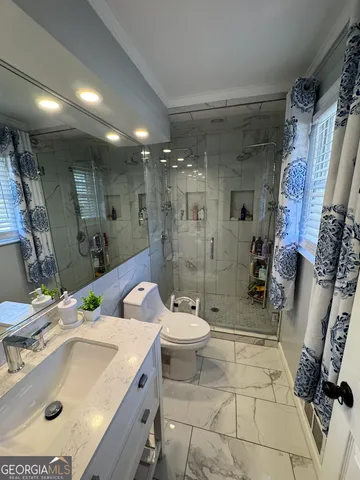 a bathroom with a sink toilet and shower