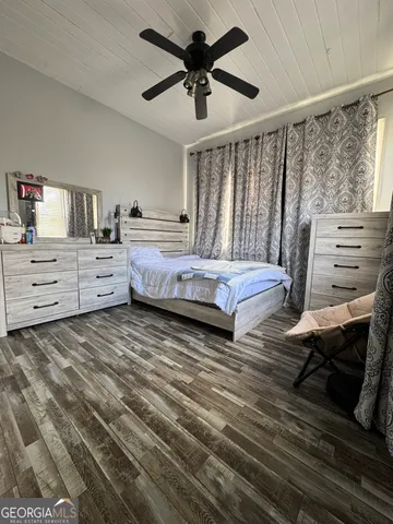 a bedroom with furniture and a large window