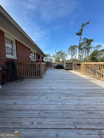 a view of a house with a wooden deck