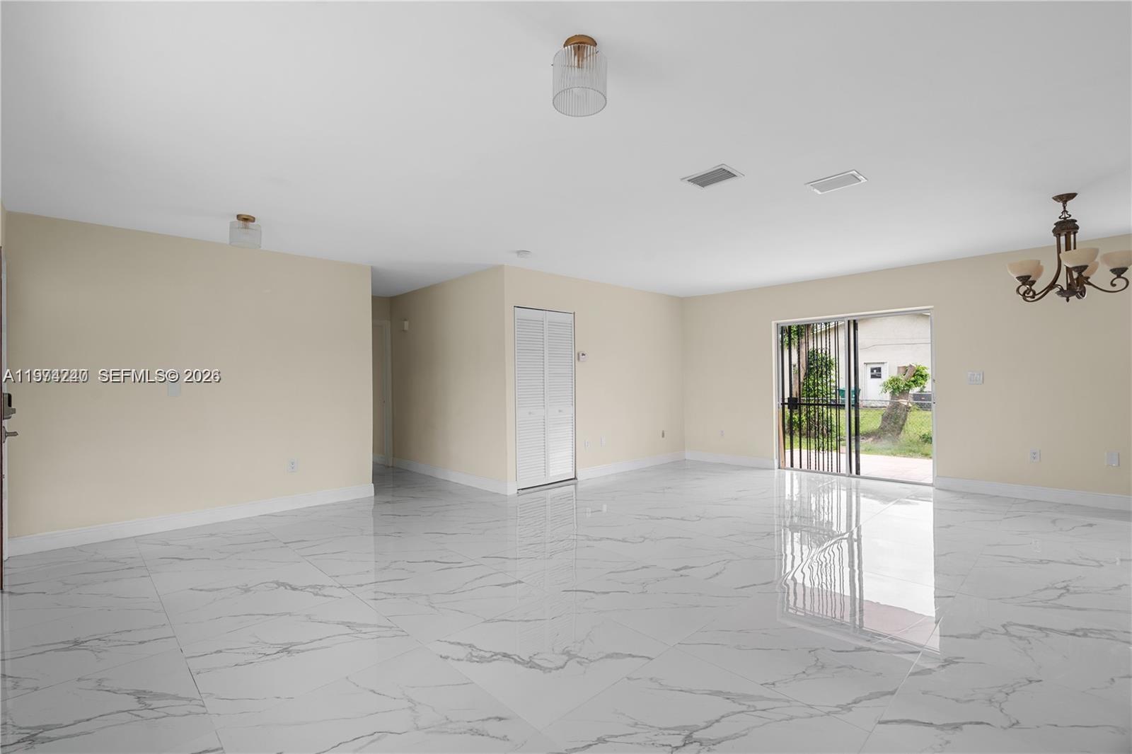 10700 Southwest 70th Street Miami, FL 33173 - Photo 4 of 19 a view of an empty room with glass door