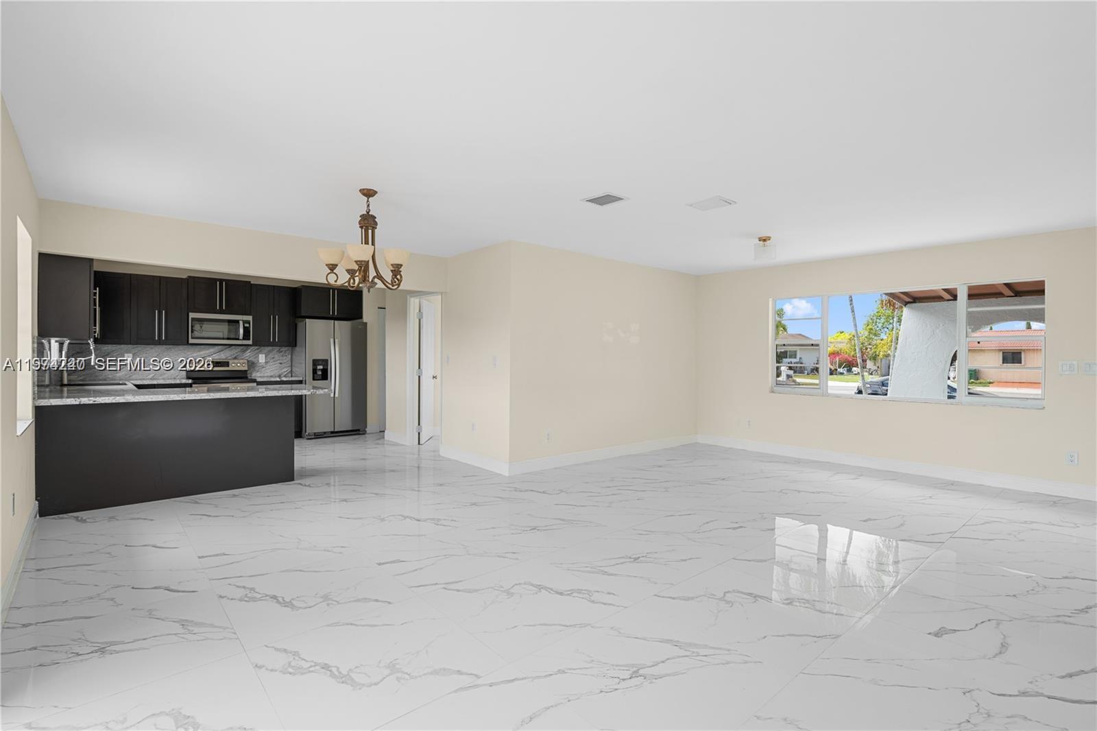 10700 Southwest 70th Street Miami, FL 33173 - Photo 6 of 19 a view of kitchen with cabinets and refrigerator