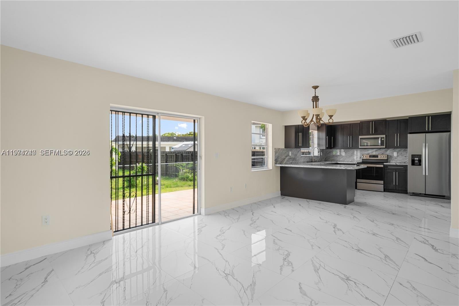 10700 Southwest 70th Street Miami, FL 33173 - Photo 7 of 19 a view of kitchen with stainless steel appliances granite countertop a stove top oven