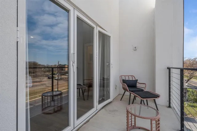 a bathroom with a glass door shower and a sink