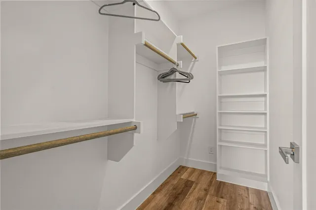 a view of walk in closet with empty racks