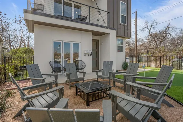 a view of a patio with table and chairs with wooden floor and fence
