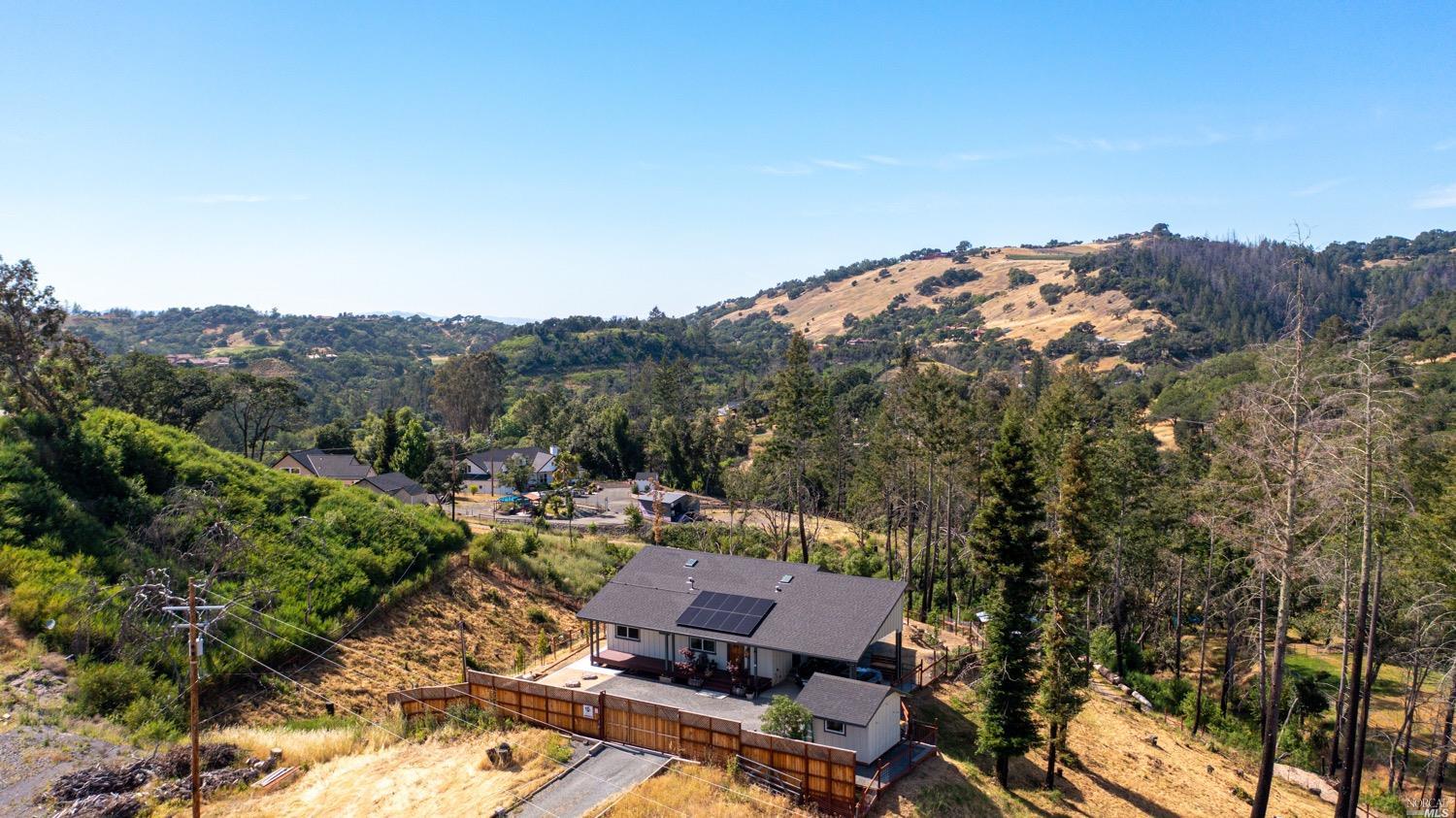 an aerial view of a house with mountain view