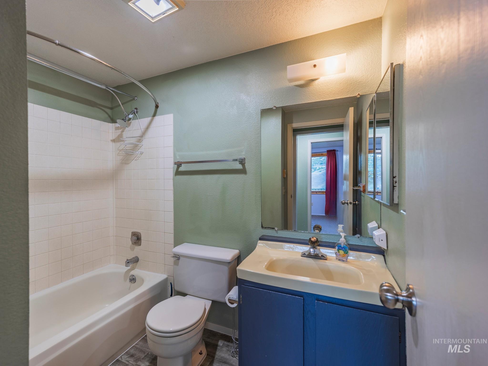 161 Cemetery Road White Bird, ID 83554 - Photo 23 of 48 Full bath with a textured wall, shower combination, and vanity