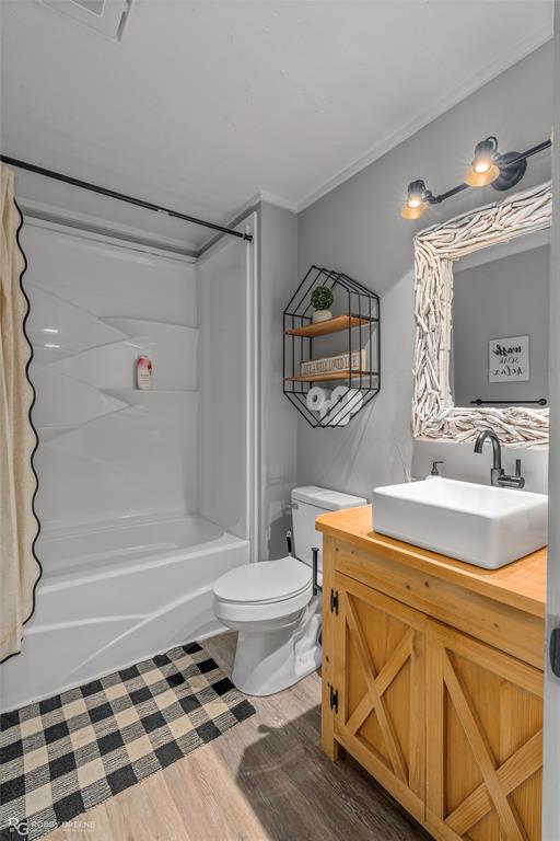 1426 Caney Lake Road Minden, LA 71055 - Photo 19 of 36 Bathroom featuring wood-finish flooring and a white built-in shower/tub combination