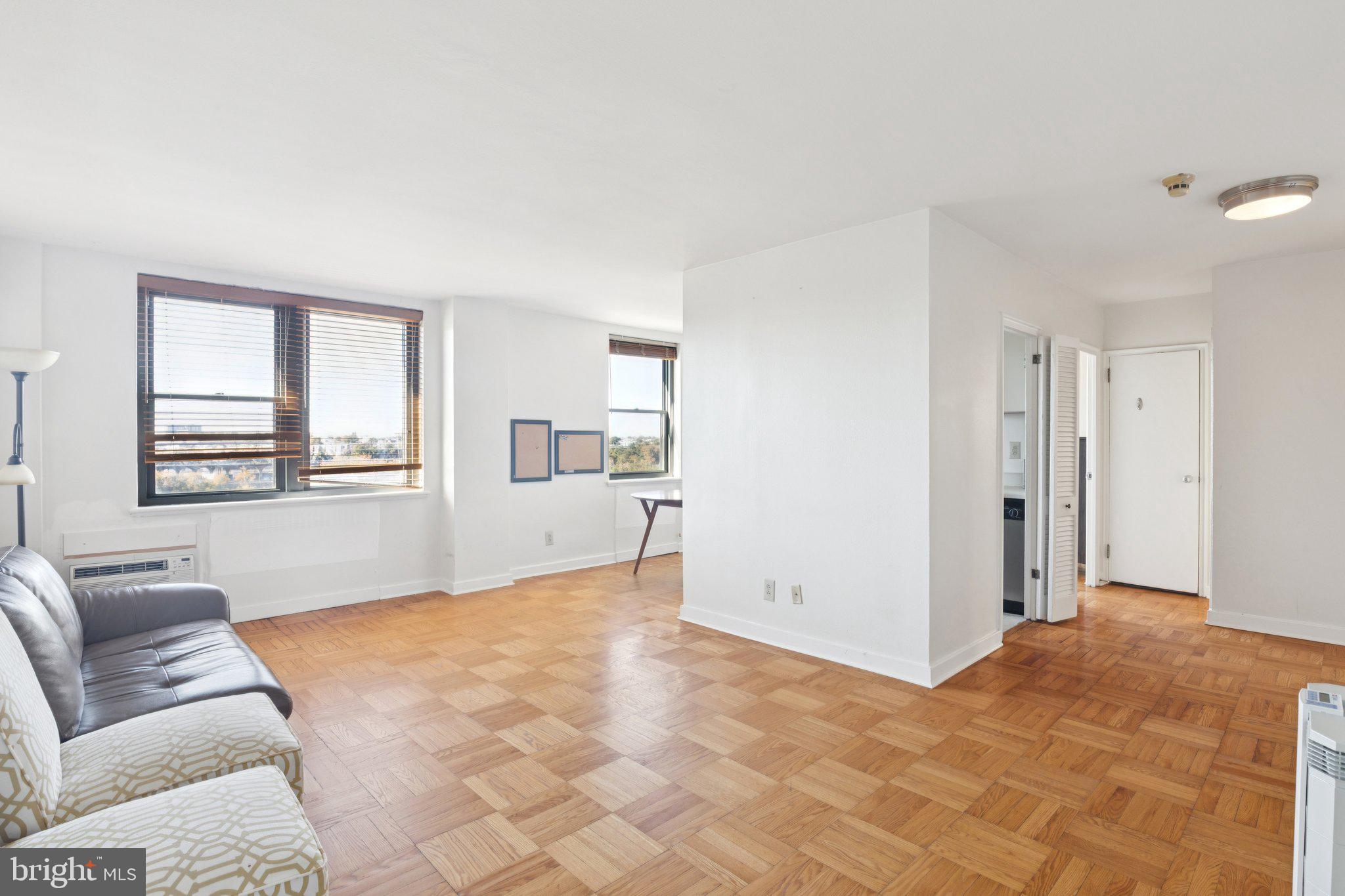 2601 Pennsylvania Avenue, Unit 848 Philadelphia, PA 19130 - Photo 1 of 12 a living room with furniture and a window