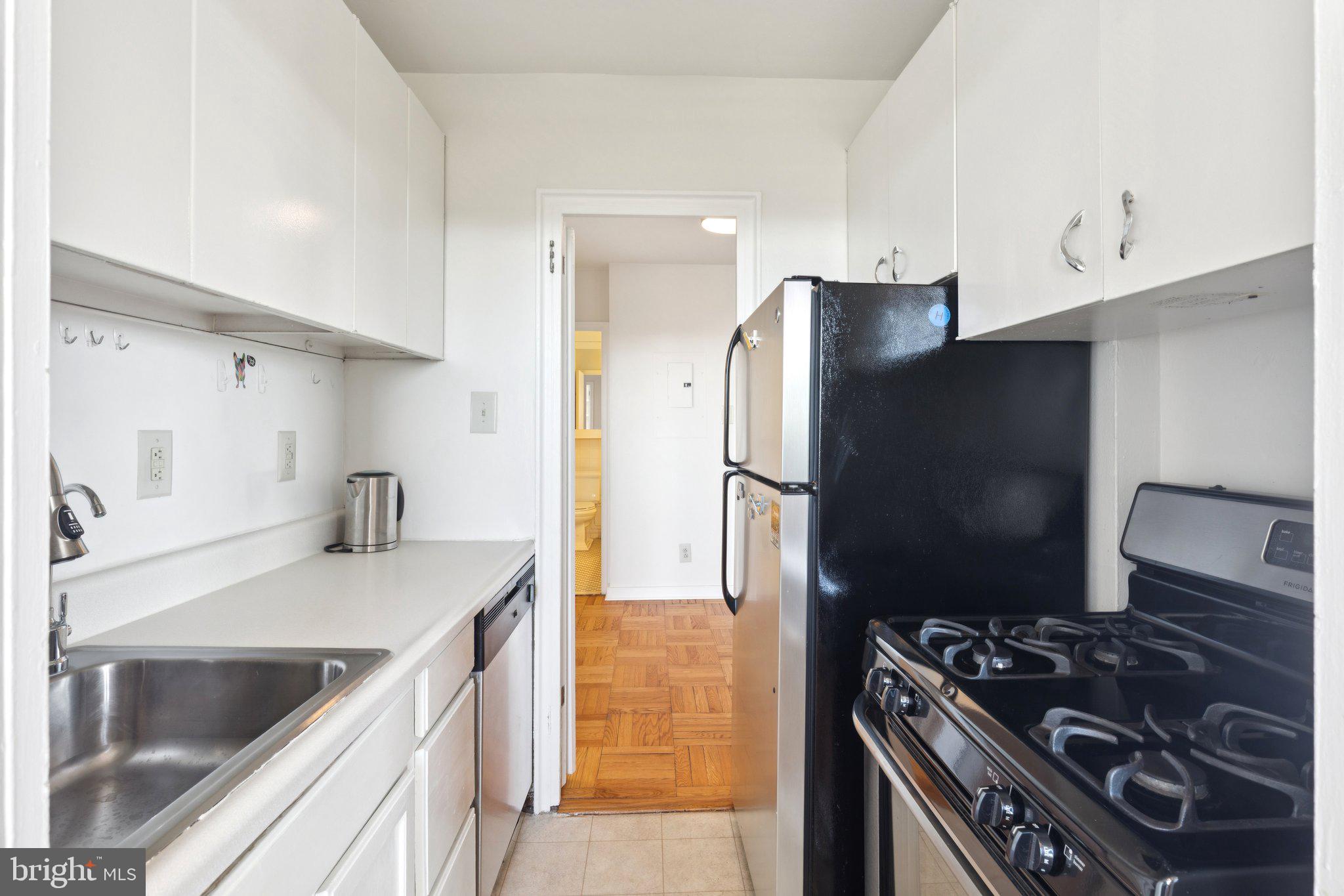 2601 Pennsylvania Avenue, Unit 848 Philadelphia, PA 19130 - Photo 5 of 12 a kitchen with stainless steel appliances granite countertop a refrigerator and a stove