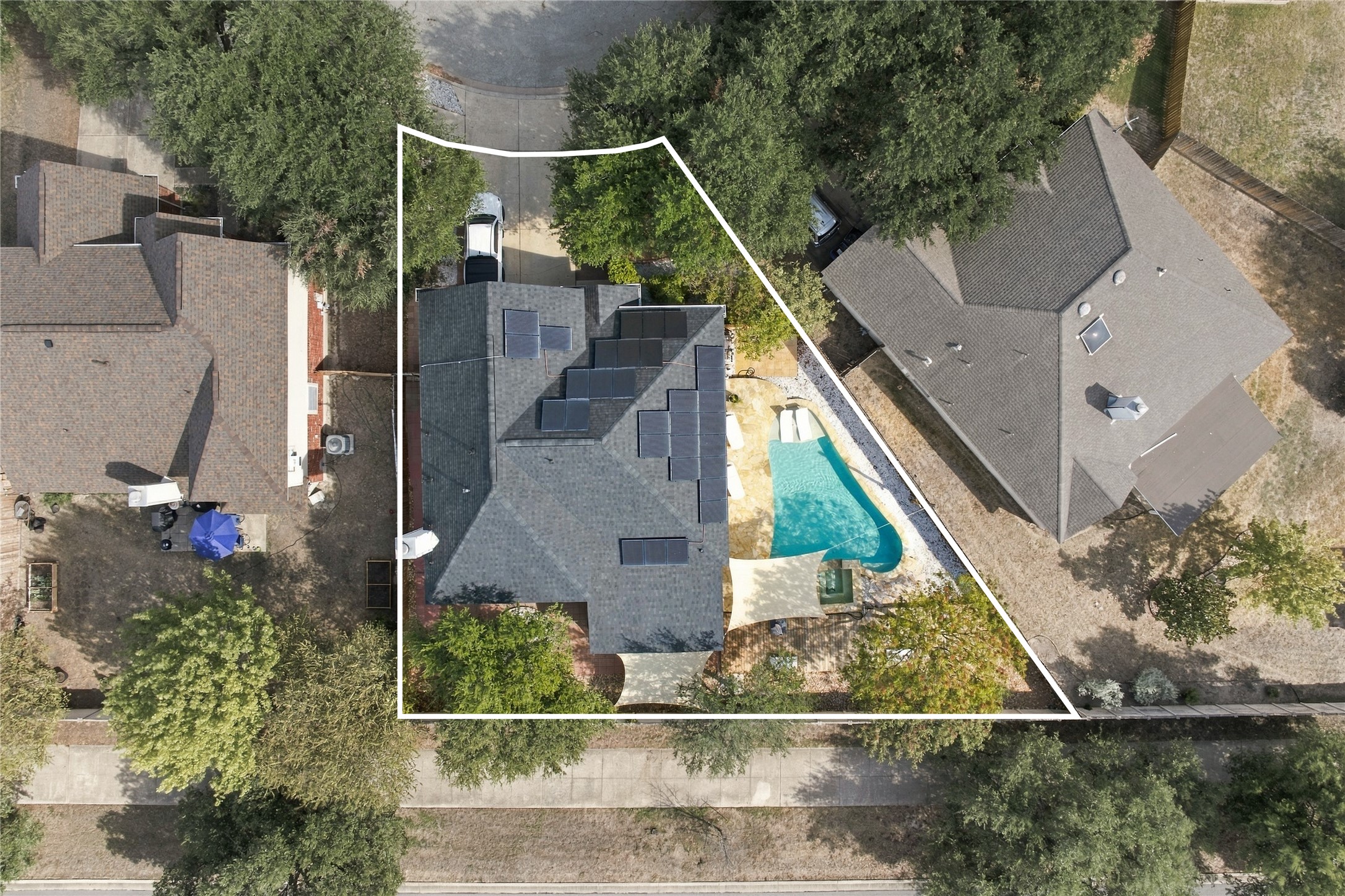 910 Point Run Drive Pflugerville, TX 78660 - Photo 37 of 39 An aerial perspective showcases the solar-equipped residence alongside a private backyard swimming pool.