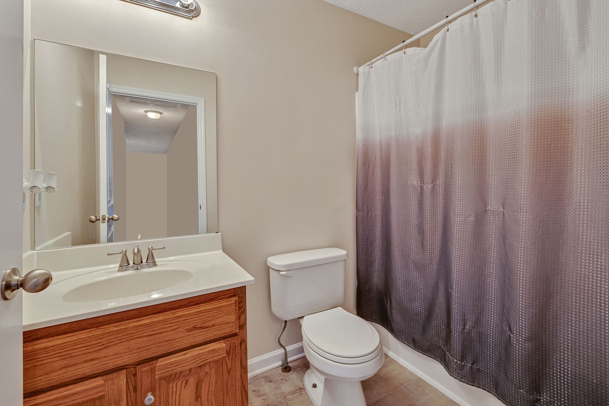 153 Spry Road Morrison, TN 37357 - Photo 12 of 19 a bathroom with a sink a toilet and shower curtain