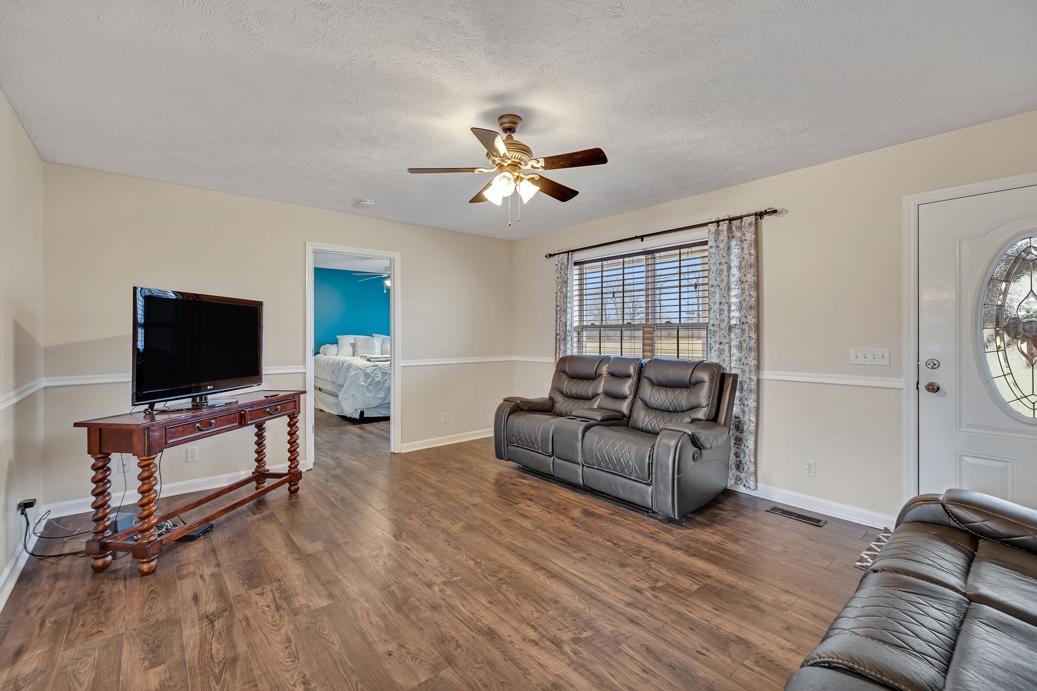 153 Spry Road Morrison, TN 37357 - Photo 3 of 19 a living room with furniture and a flat screen tv