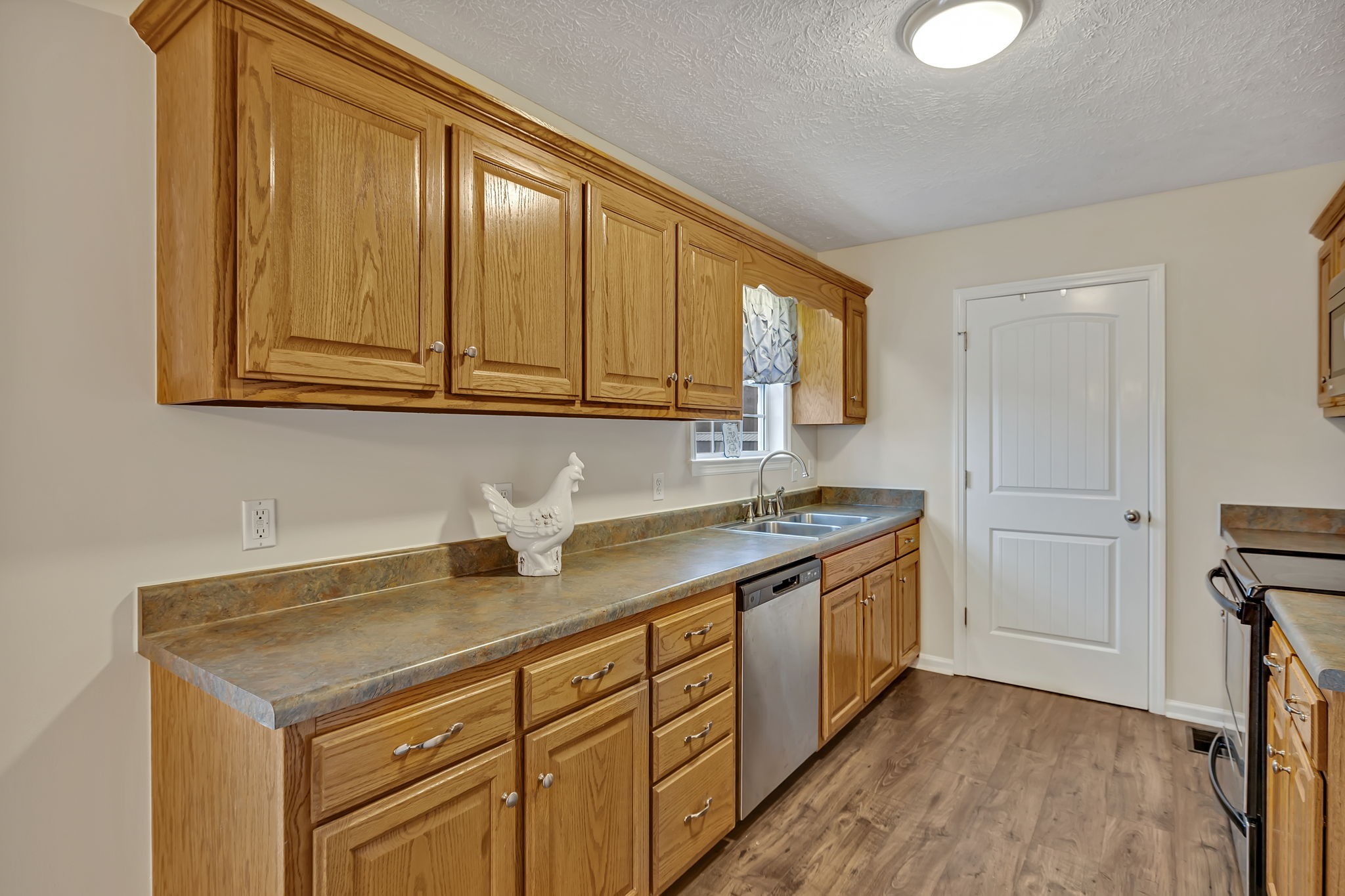 153 Spry Road Morrison, TN 37357 - Photo 5 of 19 a kitchen with stainless steel appliances granite countertop a sink stove and cabinets