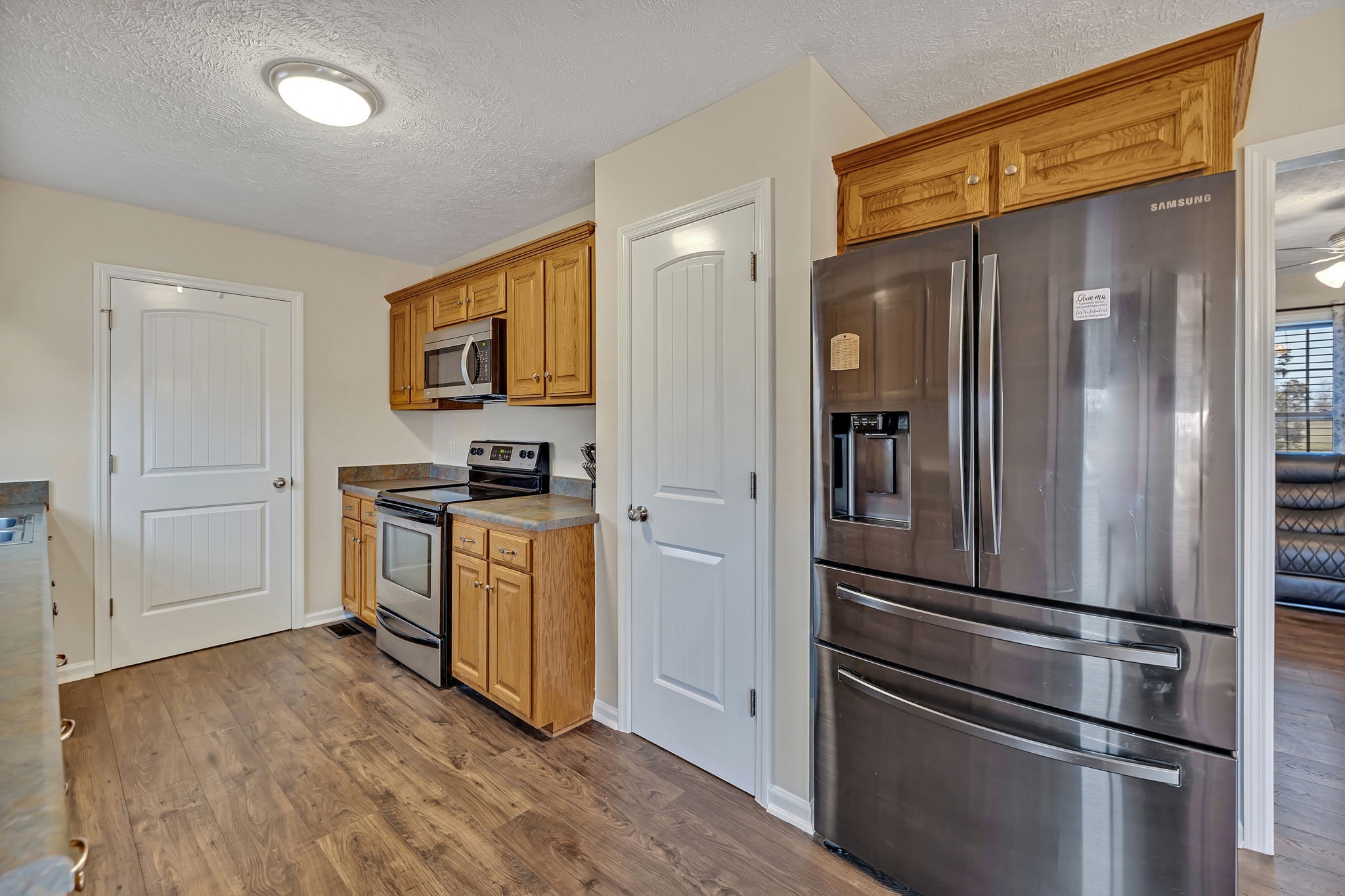 153 Spry Road Morrison, TN 37357 - Photo 6 of 19 a kitchen with a refrigerator and a stove top oven