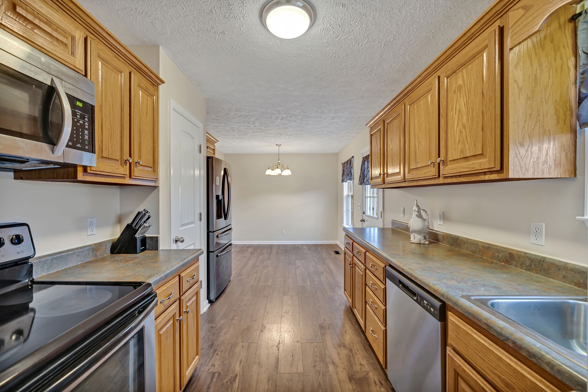 153 Spry Road Morrison, TN 37357 - Photo 7 of 19 a kitchen with stainless steel appliances granite countertop a sink a stove oven a counter space and cabinets