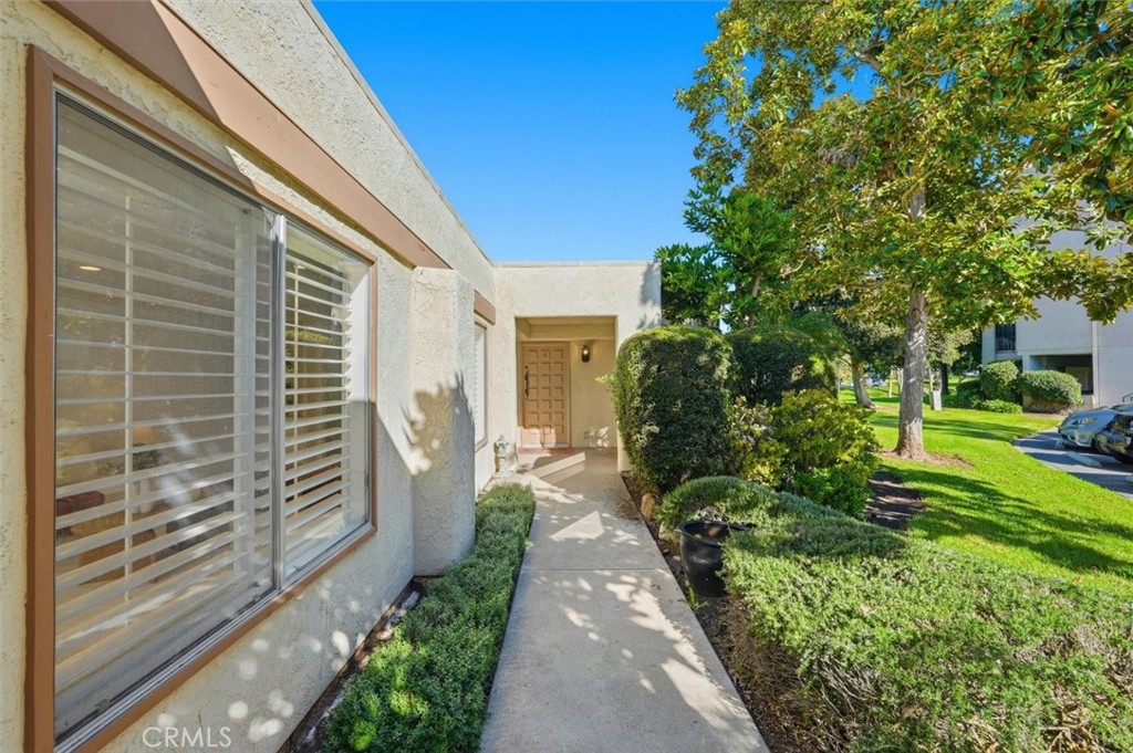 5512 West Paseo Del Lago, Unit C Laguna Woods, CA 92637 - Photo 1 of 45 a view of a pathway with a house in the background