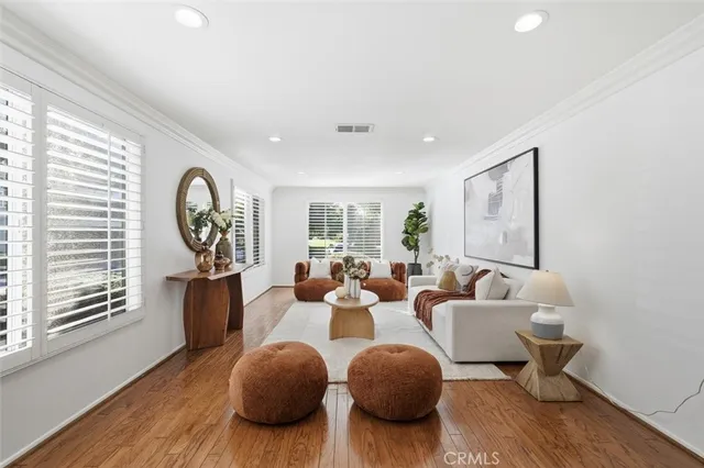 a living room with fireplace furniture and a wooden floor