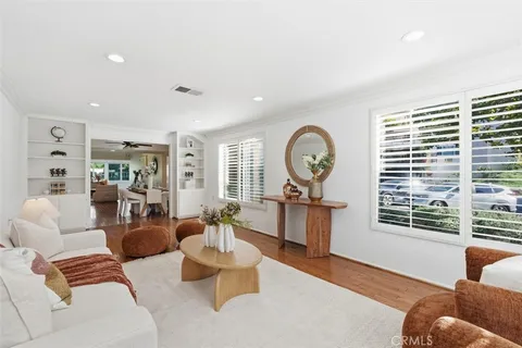 a bedroom with furniture and wooden floor