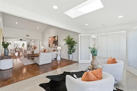 a living room with furniture and large windows