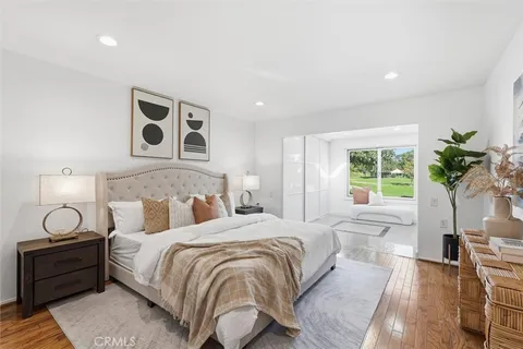 a bedroom with a bed and a painting