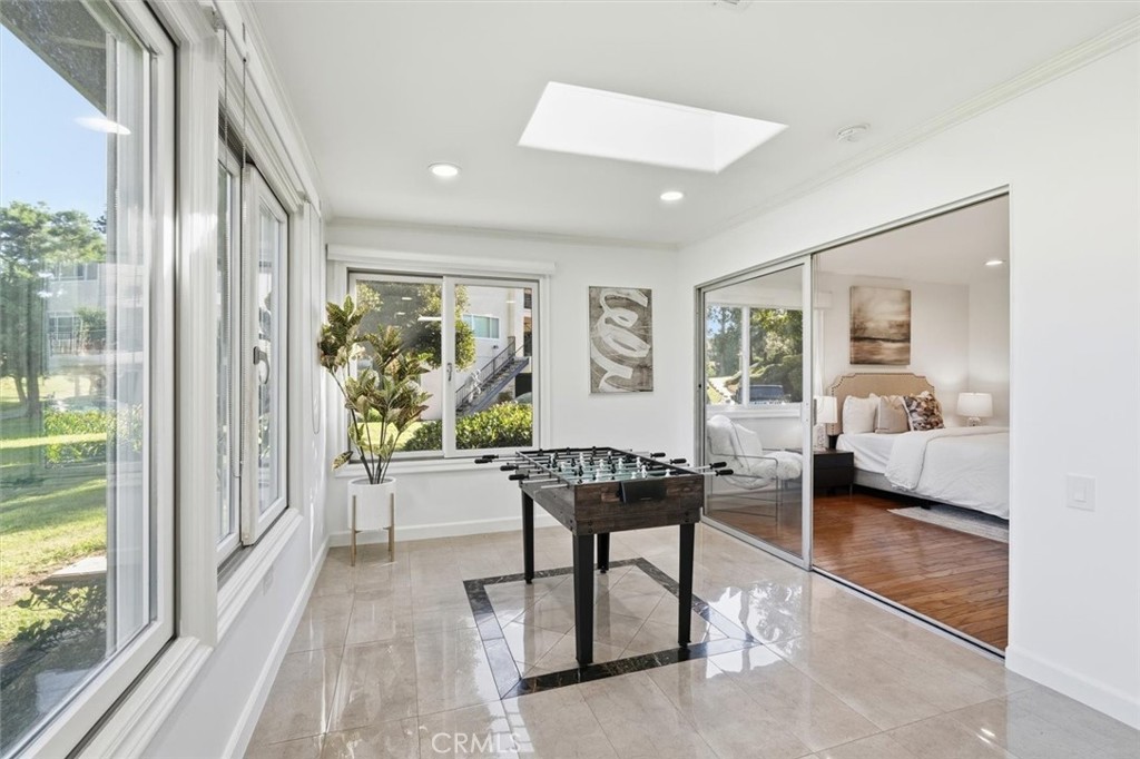 5512 West Paseo Del Lago, Unit C Laguna Woods, CA 92637 - Photo 29 of 45 a living room with furniture a large window and wooden floor