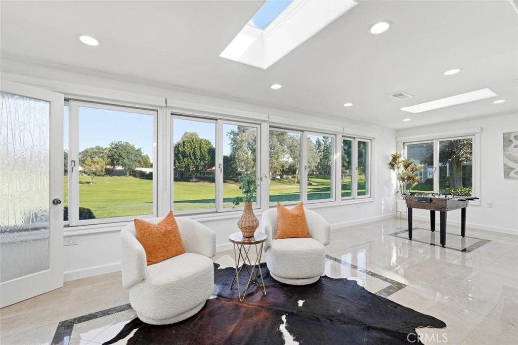5512 West Paseo Del Lago, Unit C Laguna Woods, CA 92637 - Photo 3 of 45 a living room with furniture and a large window with garden view