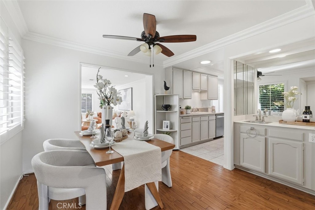5512 West Paseo Del Lago, Unit C Laguna Woods, CA 92637 - Photo 8 of 45 a kitchen with granite countertop a dining table chairs and white cabinets