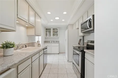 a kitchen with a sink stainless steel appliances and cabinets