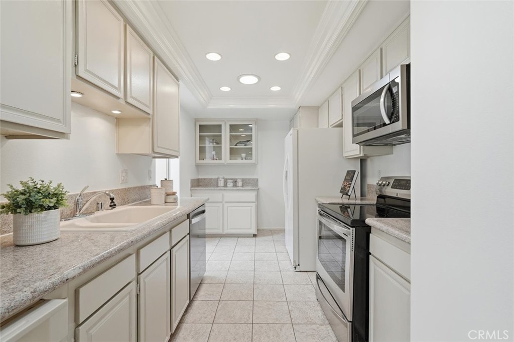 5512 West Paseo Del Lago, Unit C Laguna Woods, CA 92637 - Photo 9 of 45 a kitchen with a sink stainless steel appliances and cabinets