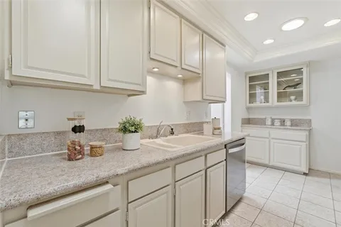 a kitchen with cabinets appliances a sink and a counter top space