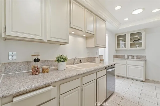 a kitchen with cabinets appliances a sink and a counter top space