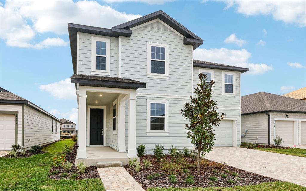 30158 Rustic Mill St Mount Mount Dora, FL 32757 - Photo 3 of 41 a view of a house with a yard and plants