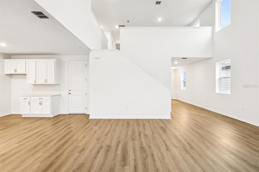 30158 Rustic Mill St Mount Mount Dora, FL 32757 - Photo 8 of 41 an empty room with wooden floor and windows
